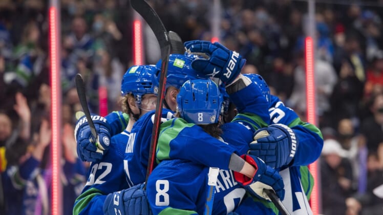 Dec 14, 2021; Vancouver, British Columbia, CAN; Vancouver Canucks forward Elias Pettersson (40) and forward Conor Garland (8) celebrate Pettersson s goal against the Columbus Blue Jackets in the third period at Rogers Arena. Vancouver Won 4-3. Mandatory Credit: Bob Frid-USA TODAY Sports