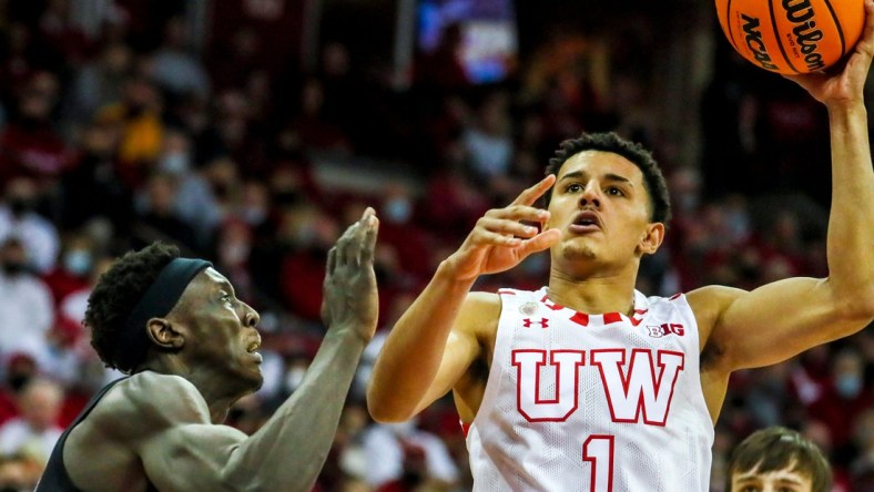 Wisconsin Badgers guard Johnny Davis drives to the basket as Marquette forward Kur Kuath  defends him during the first half on Dec. 4, 2021.

Mjs 12042021 Uwmen05 Ec00003