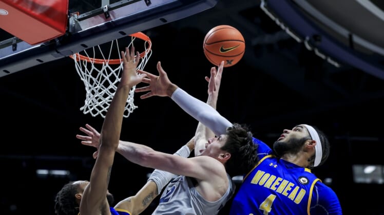 Dec 15, 2021; Cincinnati, Ohio, USA;  Morehead State Eagles forward Jaylen Sebree (left) defends against Xavier Musketeers forward Zach Freemantle (middle) as he drives to the basket Morehead State Eagles forward Johni Broome (4) in the first half at the Cintas Center. Mandatory Credit: Aaron Doster-USA TODAY Sports