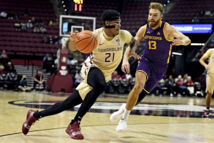 Dec 15, 2021; Tallahassee, Florida, USA; Florida State Seminoles guard Cam'Ron Fletcher (21) drives past Lipscomb Bisons forward Parker Hazan (13) during the first half at Donald L. Tucker Center. Mandatory Credit: Melina Myers-USA TODAY Sports