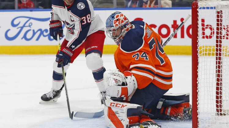 Dec 16, 2021; Edmonton, Alberta, CAN; Edmonton Oilers goaltender Stuart Skinner (74)  makes a save on a shot by Columbus Blue Jackets forward Boone Jenner (38) during the second period at Rogers Place. Mandatory Credit: Perry Nelson-USA TODAY Sports