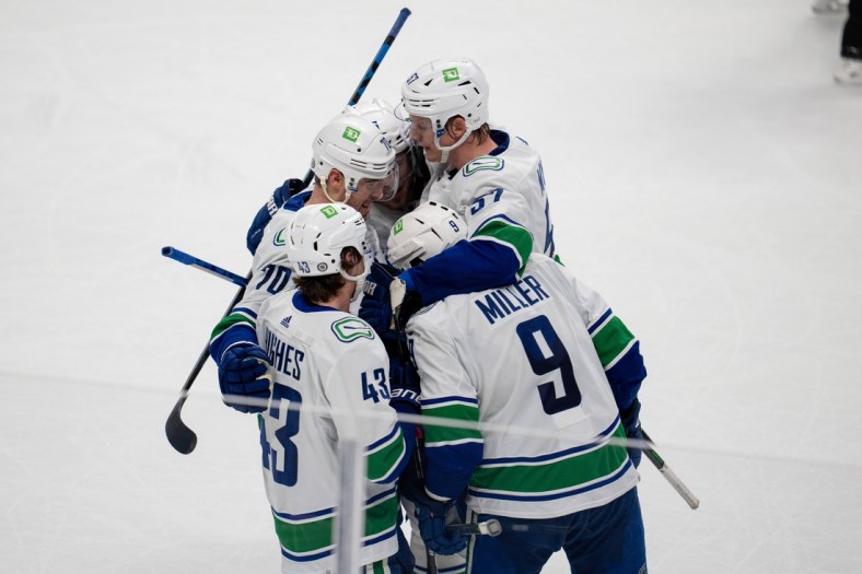 Dec 16, 2021; San Jose, California, USA; Vancouver Canucks center J.T. Miller (9), defenseman Quinn Hughes (43), defenseman Tyler Myers (57) and left wing Tanner Pearson (70) celebrate after a goal during the third period against the San Jose Sharksat SAP Center at San Jose. Mandatory Credit: Neville E. Guard-USA TODAY Sports