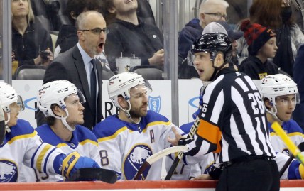 Dec 17, 2021; Pittsburgh, Pennsylvania, USA;  Buffalo Sabres head coach Don Granato (left) reacts to referee Jake Brenk (26) against the Pittsburgh Penguins during the first period at PPG Paints Arena. Mandatory Credit: Charles LeClaire-USA TODAY Sports