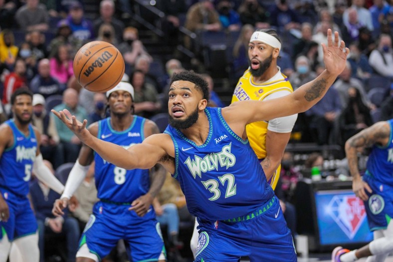 Dec 17, 2021; Minneapolis, Minnesota, USA; Minnesota Timberwolves center Karl-Anthony Towns (32) gets a loose ball against the Los Angeles Lakers in the first quarter at Target Center. Mandatory Credit: Brad Rempel-USA TODAY Sports