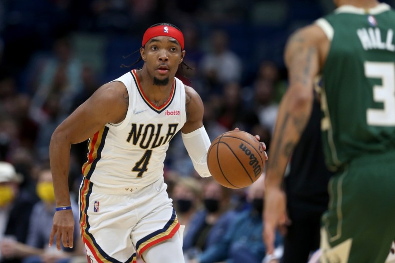 Dec 17, 2021; New Orleans, Louisiana, USA; New Orleans Pelicans guard Devonte' Graham (4) dribbles up court against the Milwaukee Bucks in the second quarter at the Smoothie King Center. Mandatory Credit: Chuck Cook-USA TODAY Sports