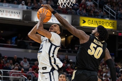 Dec 18, 2021; Indianapolis, Indiana, USA; Butler Bulldogs guard Aaron Thompson (2) shoots the ball while Purdue Boilermakers forward Trevion Williams (50) defends in the second half at Gainbridge Fieldhouse. Mandatory Credit: Trevor Ruszkowski-USA TODAY Sports