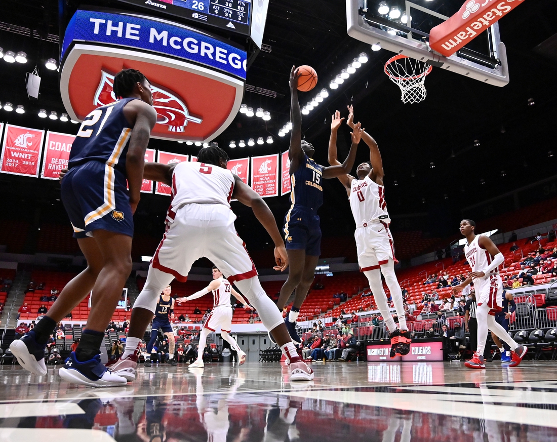 Dec 18, 2021; Pullman, Washington, USA; Northern Colorado Bears forward Kur Jongkuch (15) shoots the ball against Washington State Cougars forward Efe Abogidi (0) in the second half at Friel Court at Beasley Coliseum. Cougars won 82-56. Mandatory Credit: James Snook-USA TODAY Sports