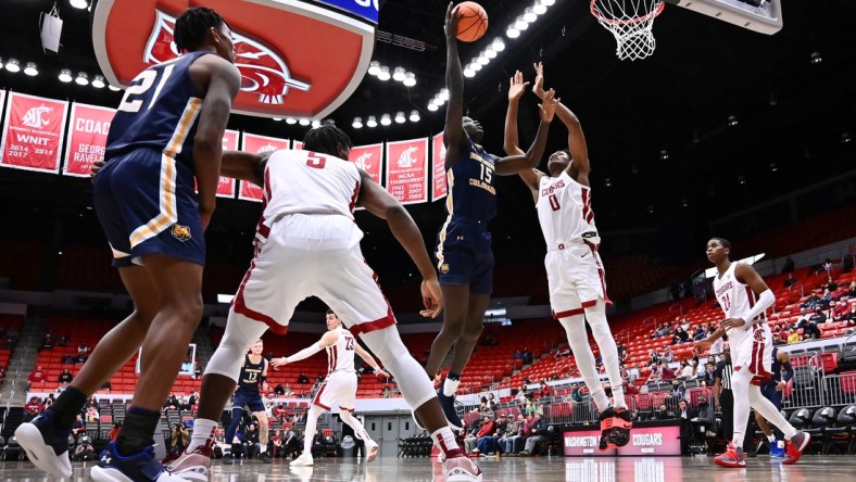 Dec 18, 2021; Pullman, Washington, USA; Northern Colorado Bears forward Kur Jongkuch (15) shoots the ball against Washington State Cougars forward Efe Abogidi (0) in the second half at Friel Court at Beasley Coliseum. Cougars won 82-56. Mandatory Credit: James Snook-USA TODAY Sports