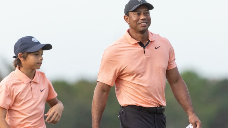 Dec 18, 2021; Orlando, Florida, USA; Tiger Woods walks off 18th green during the first round of the PNC Championship golf tournament at Grande Lakes Orlando Course. Mandatory Credit: Jeremy Reper-USA TODAY Sports