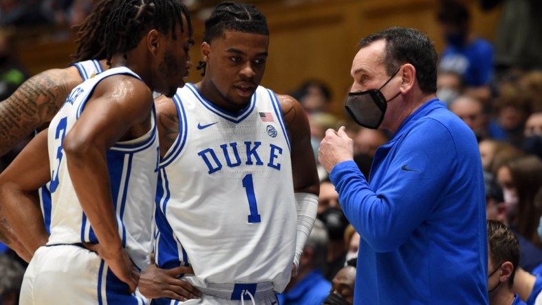 Dec 18, 2021; Durham, North Carolina, USA; Duke Blue Devils head coach Mike Krzyzewski (right) talks to guard Trevor Keels (1) and guard Jeremy Roach (3) during a timeout in the first half against the Elon Phoenix at Cameron Indoor Stadium. Mandatory Credit: Rob Kinnan-USA TODAY Sports