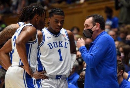 Dec 18, 2021; Durham, North Carolina, USA; Duke Blue Devils head coach Mike Krzyzewski (right) talks to guard Trevor Keels (1) and guard Jeremy Roach (3) during a timeout in the first half against the Elon Phoenix at Cameron Indoor Stadium. Mandatory Credit: Rob Kinnan-USA TODAY Sports