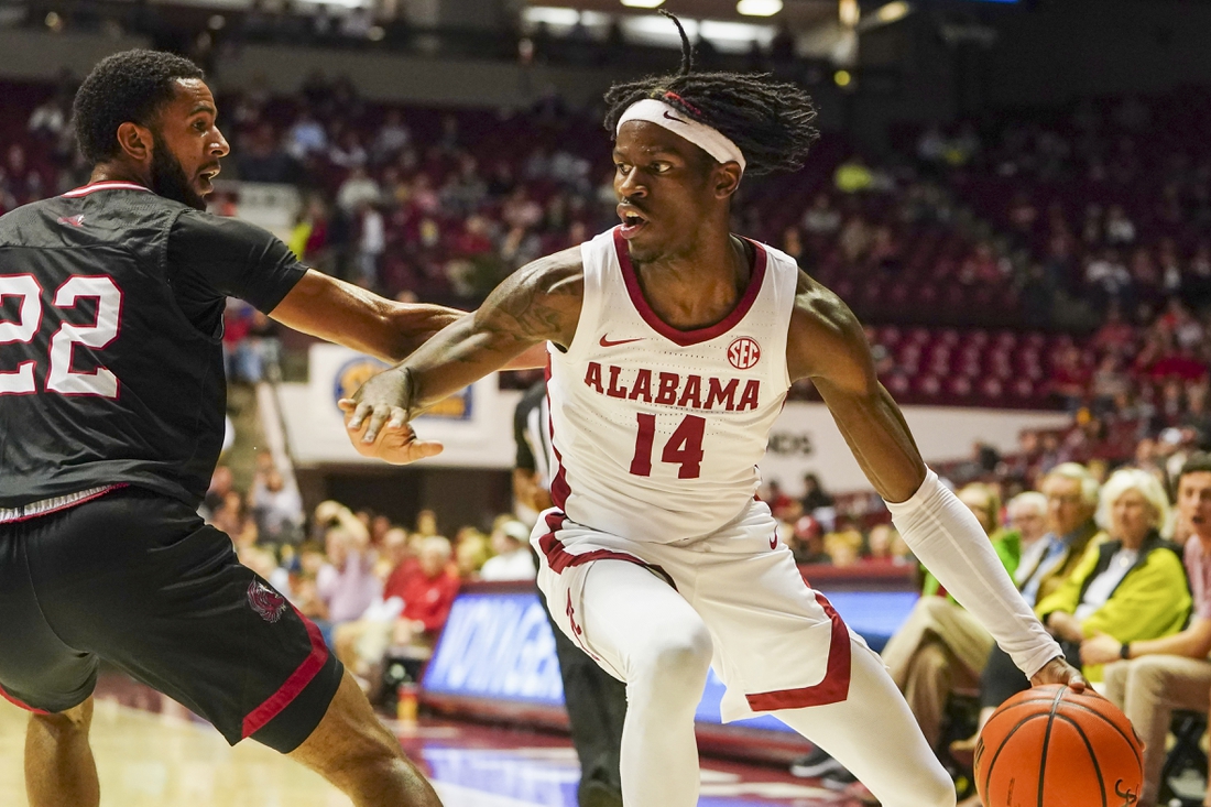 Dec 18, 2021; Tuscaloosa, Alabama, USA; Alabama Crimson Tide guard Keon Ellis (14) drives to the basket against Jacksonville State Gamecocks guard Jalen Gibbs (22) during the first half at Coleman Coliseum. Mandatory Credit: Marvin Gentry-USA TODAY Sports