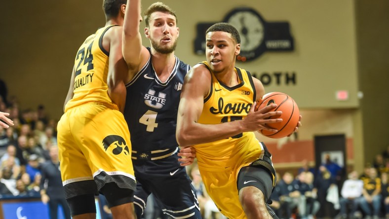 Dec 18, 2021; Sioux Falls, South Dakota, USA;  Iowa Hawkeyes forward Keegan Murray (15) drives on Utah State Aggies forward Brandon Horvath (4) in the second half at Sanford Pentagon. Mandatory Credit: Steven Branscombe-USA TODAY Sports