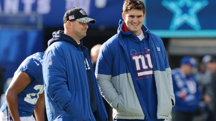 Dec 19, 2021; East Rutherford, New Jersey, USA; New York Giants head coach Joe Judge (left) talks with quarterback Daniel Jones (8) before the game against the Dallas Cowboys at MetLife Stadium. Mandatory Credit: Vincent Carchietta-USA TODAY Sports