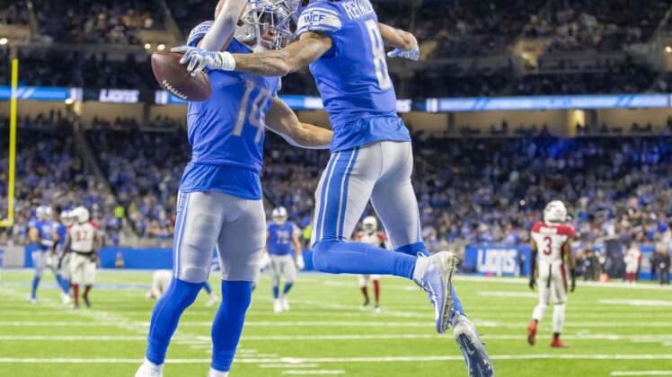 Dec 19, 2021; Detroit, Michigan, USA; Detroit Lions wide receiver Josh Reynolds (8) catches a pass for a TD and celebrates with receiver Amon-Ra St. Brown (14) during the first half against the Arizona Cardinals at Ford Field. Mandatory Credit: David Reginek-USA TODAY Sports