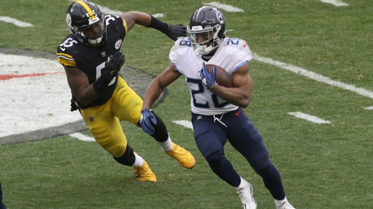 Dec 19, 2021; Pittsburgh, Pennsylvania, USA;  Tennessee Titans running back Jeremy McNichols (28) runs the ball against Pittsburgh Steelers inside linebacker Devin Bush (55) during the second quarter at Heinz Field. Mandatory Credit: Charles LeClaire-USA TODAY Sports