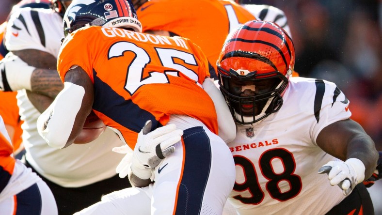 Cincinnati Bengals nose tackle D.J. Reader (98) tackles Denver Broncos running back Melvin Gordon (25) in the first half the NFL football game between the Cincinnati Bengals and the Denver Broncos on Sunday, Dec. 19, 2021, at Empower Field in Denver, Co.

Cincinnati Bengals At Denver Broncos 371