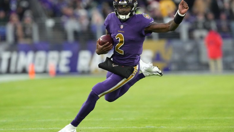 Dec 19, 2021; Baltimore, Maryland, USA; Baltimore Ravens quarterback Tyler Huntley (2) runs the ball in the first quarter against the Green Bay Packers at M&T Bank Stadium. Mandatory Credit: Mitch Stringer-USA TODAY Sports