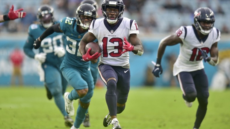 Houston Texans wide receiver Brandin Cooks (13) scores the final touchdown for Houston as Jacksonville Jaguars cornerback Tyson Campbell (32) can't make the tackle during the fourth quarter Sunday, Dec. 2021 at TIAA Bank Field in Jacksonville. The Jaguars hosted the Texans during a regular season NFL game. Houston defeated Jacksonville 30-16. [Corey Perrine/Florida Times-Union]Jki 121921 Jagstexans 26