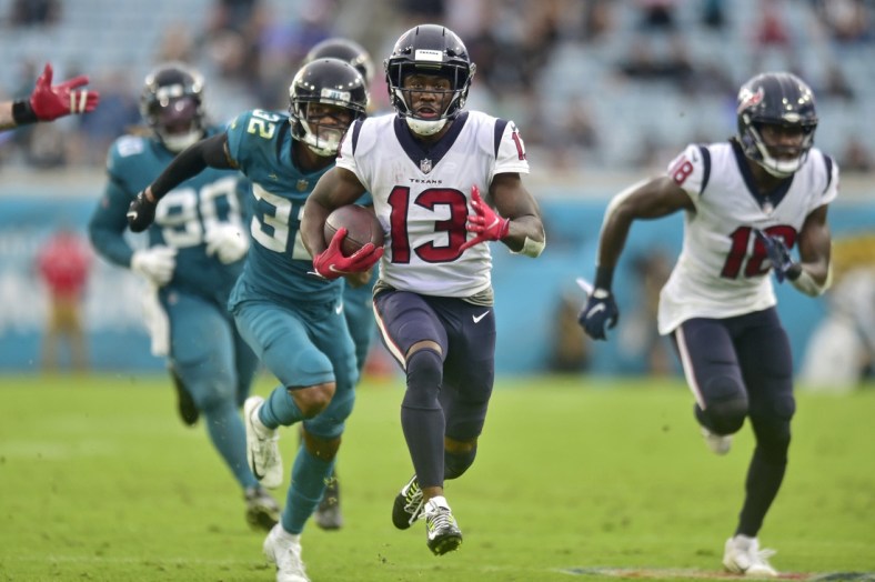 Houston Texans wide receiver Brandin Cooks (13) scores the final touchdown for Houston as Jacksonville Jaguars cornerback Tyson Campbell (32) can't make the tackle during the fourth quarter Sunday, Dec. 2021 at TIAA Bank Field in Jacksonville. The Jaguars hosted the Texans during a regular season NFL game. Houston defeated Jacksonville 30-16. [Corey Perrine/Florida Times-Union]Jki 121921 Jagstexans 26