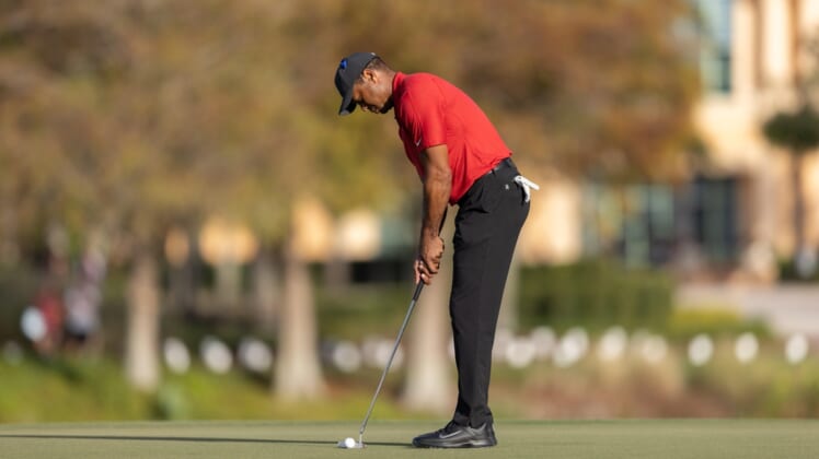 Dec 19, 2021; Orlando, Florida, USA; Tiger Woods putts on the 18th green during the final round of the PNC Championship golf tournament at Grande Lakes Orlando Course. Mandatory Credit: Jeremy Reper-USA TODAY Sports