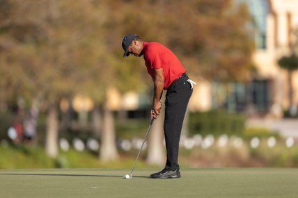 Dec 19, 2021; Orlando, Florida, USA; Tiger Woods putts on the 18th green during the final round of the PNC Championship golf tournament at Grande Lakes Orlando Course. Mandatory Credit: Jeremy Reper-USA TODAY Sports