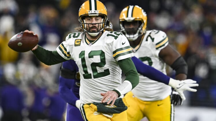 Dec 19, 2021; Baltimore, Maryland, USA;  during Green Bay Packers quarterback Aaron Rodgers (12) throws on the run during the first half against the Baltimore Ravens at M&T Bank Stadium. Mandatory Credit: Tommy Gilligan-USA TODAY Sports