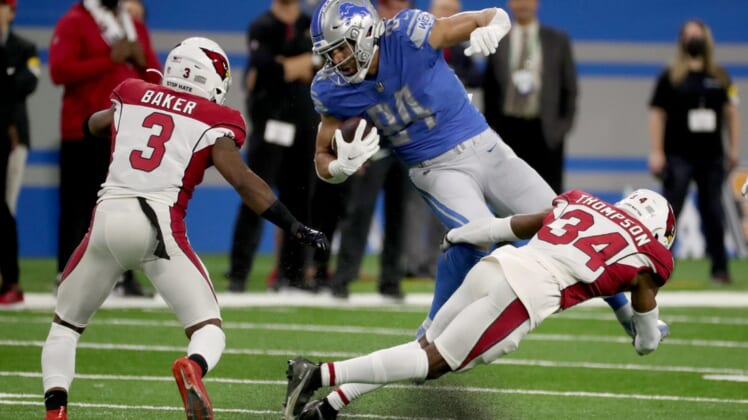 Detroit Lions tight end Shane Zylstra (84) is tackled by Arizona Cardinals free safety Jalen Thompson (34) during second half action on Sunday, Dec. 19, 2021, at Ford Field in Detroit.Lions Ariz