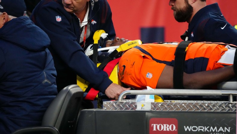 Dec 19, 2021; Denver, Colorado, USA; Denver Broncos quarterback Teddy Bridgewater (5) is carted off the field in the third quarter against the Cincinnati Bengals at Empower Field at Mile High Mandatory Credit: Ron Chenoy-USA TODAY Sports