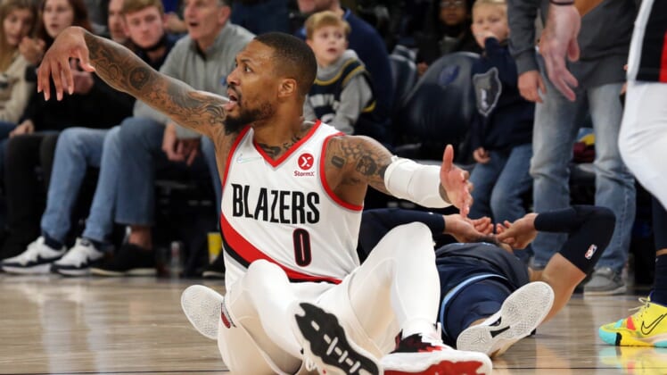 Dec 19, 2021; Memphis, Tennessee, USA; Portland Trail Blazers guard Damian Lillard (0) reacts after a foul call on Memphis Grizzles guard Dillon Brooks (24) late in the fourth quarter at FedExForum. Mandatory Credit: Petre Thomas-USA TODAY Sports