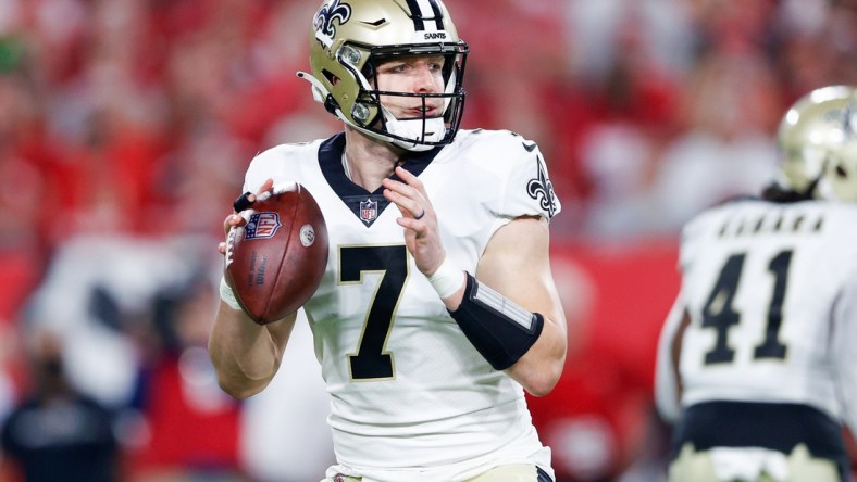 Dec 19, 2021; Tampa, Florida, USA;  New Orleans Saints quarterback Taysom Hill (7) drops back to pass in the first quarter against the Tampa Bay Buccaneers at Raymond James Stadium. Mandatory Credit: Nathan Ray Seebeck-USA TODAY Sports