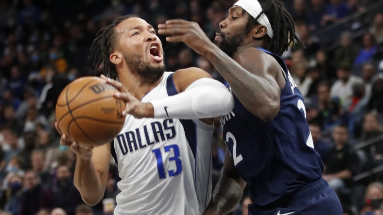 Dec 19, 2021; Minneapolis, Minnesota, USA; Dallas Mavericks guard Jalen Brunson (13) works around Minnesota Timberwolves guard Patrick Beverley (22) in the first quarter at Target Center. Mandatory Credit: Bruce Kluckhohn-USA TODAY Sports