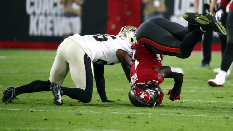 Dec 19, 2021; Tampa, Florida, USA; Tampa Bay Buccaneers wide receiver Chris Godwin (14) falls on his head after he catches the ball against the New Orleans Saints during the first half at Raymond James Stadium. Mandatory Credit: Kim Klement-USA TODAY Sports