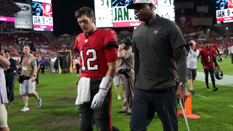 Dec 19, 2021; Tampa, Florida, USA; Tampa Bay Buccaneers quarterback Tom Brady (12) and offensive coordinator Byron Leftwich walks off the field as they lost to the New Orleans Saints at Raymond James Stadium. Mandatory Credit: Kim Klement-USA TODAY Sports