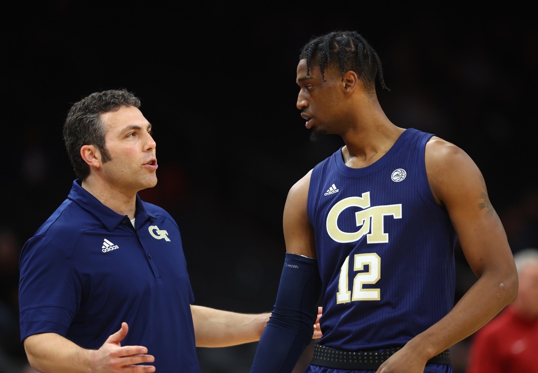 Dec 18, 2021; Phoenix, Arizona, USA; Georgia Tech Yellow Jackets head coach Josh Pastner talks to forward Khalid Moore (12) against the Southern California Trojans during the Colangelo Classic at Footprint Center. Mandatory Credit: Mark J. Rebilas-USA TODAY Sports