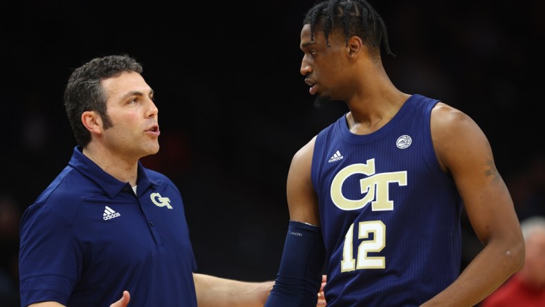 Dec 18, 2021; Phoenix, Arizona, USA; Georgia Tech Yellow Jackets head coach Josh Pastner talks to forward Khalid Moore (12) against the Southern California Trojans during the Colangelo Classic at Footprint Center. Mandatory Credit: Mark J. Rebilas-USA TODAY Sports