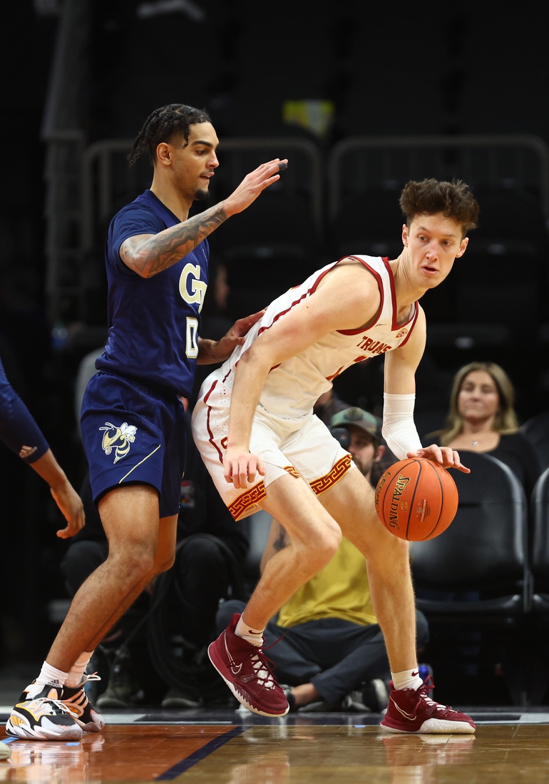 Dec 18, 2021; Phoenix, Arizona, USA; Southern California Trojans guard Drew Peterson (right) controls the ball against Georgia Tech Yellow Jackets guard Michael Devoe during the Colangelo Classic at Footprint Center. Mandatory Credit: Mark J. Rebilas-USA TODAY Sports