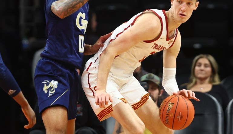 Dec 18, 2021; Phoenix, Arizona, USA; Southern California Trojans guard Drew Peterson (right) controls the ball against Georgia Tech Yellow Jackets guard Michael Devoe during the Colangelo Classic at Footprint Center. Mandatory Credit: Mark J. Rebilas-USA TODAY Sports