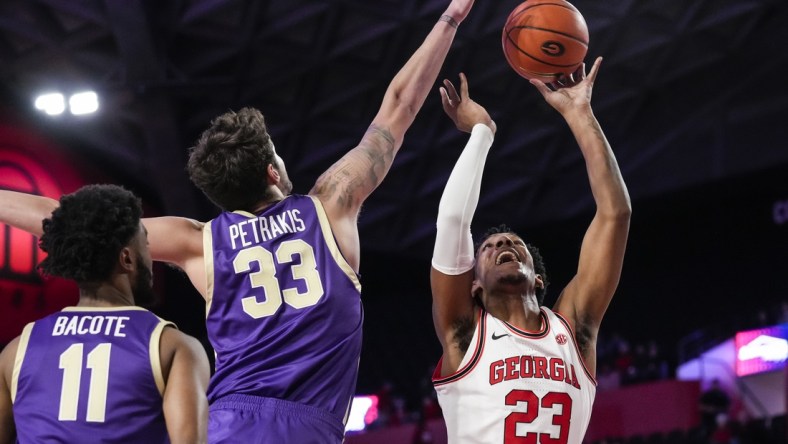 Dec 20, 2021; Athens, Georgia, USA; Georgia Bulldogs guard Braelen Bridges (23) shoots against Western Carolina Catamounts forward Joe Petrakis (33) during the first half at Stegeman Coliseum. Mandatory Credit: Dale Zanine-USA TODAY Sports