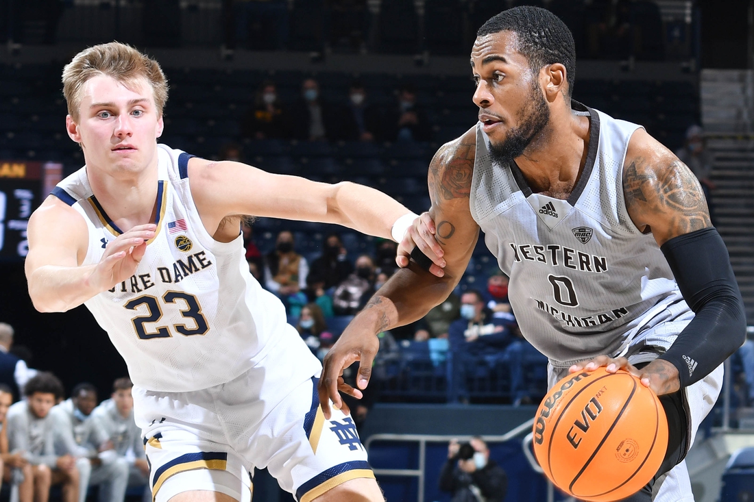 Dec 20, 2021; South Bend, Indiana, USA; Western Michigan Broncos forward Markeese Hastings (0) drives to the basket as Notre Dame Fighting Irish guard Dane Goodwin (23) defends in the first half at the Purcell Pavilion. Mandatory Credit: Matt Cashore-USA TODAY Sports