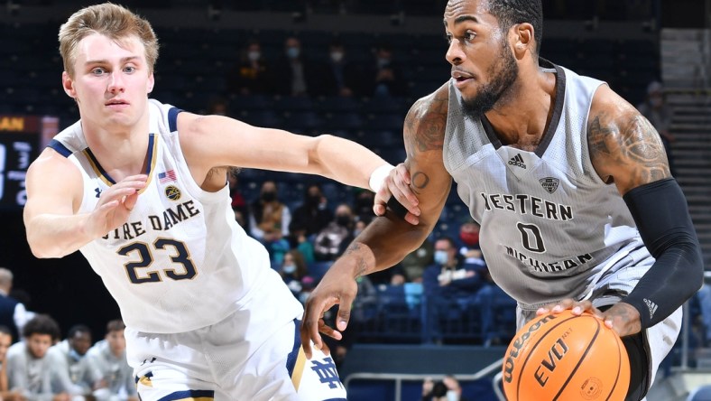 Dec 20, 2021; South Bend, Indiana, USA; Western Michigan Broncos forward Markeese Hastings (0) drives to the basket as Notre Dame Fighting Irish guard Dane Goodwin (23) defends in the first half at the Purcell Pavilion. Mandatory Credit: Matt Cashore-USA TODAY Sports