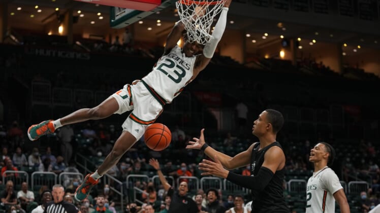 Dec 20, 2021; Coral Gables, Florida, USA; Miami Hurricanes guard Kameron McGusty (23) finishes a dunk over Stetson Hatters guard Christiaan Jones (0) during the second half at Watsco Center. Mandatory Credit: Jasen Vinlove-USA TODAY Sports