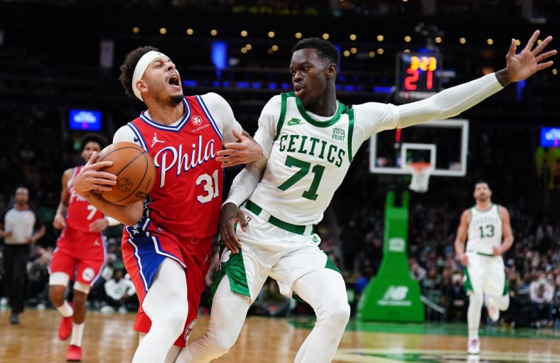 Dec 20, 2021; Boston, Massachusetts, USA; Philadelphia 76ers guard Seth Curry (31) is fouled by Boston Celtics guard Dennis Schroder (71) in the second quarter at TD Garden. Mandatory Credit: David Butler II-USA TODAY Sports