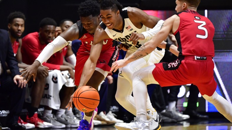 Dec 20, 2021; West Lafayette, Indiana, USA;  Purdue Boilermakers guard Jaden Ivey (23) goes for a loose ball against Incarnate Word Cardinals guard Josh Morgan (13) and Incarnate Word Cardinals guard Drew Lutz (3) during the second half at Mackey Arena.  Boilermakers won 79-59. Mandatory Credit: Marc Lebryk-USA TODAY Sports