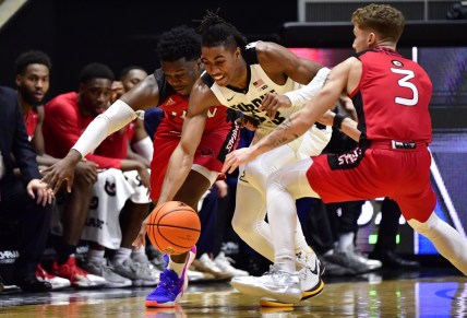 Dec 20, 2021; West Lafayette, Indiana, USA;  Purdue Boilermakers guard Jaden Ivey (23) goes for a loose ball against Incarnate Word Cardinals guard Josh Morgan (13) and Incarnate Word Cardinals guard Drew Lutz (3) during the second half at Mackey Arena.  Boilermakers won 79-59. Mandatory Credit: Marc Lebryk-USA TODAY Sports