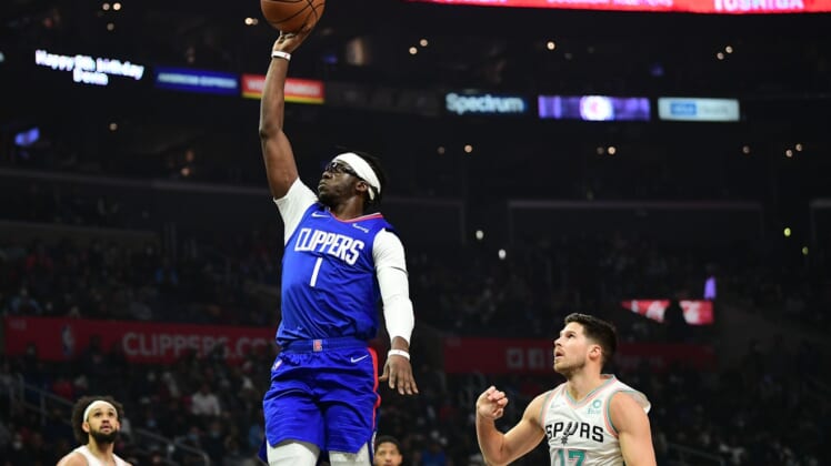 Dec 20, 2021; Los Angeles, California, USA; Los Angeles Clippers guard Reggie Jackson (1) shoots ahead of San Antonio Spurs forward Doug McDermott (17) during the first half at Staples Center. Mandatory Credit: Gary A. Vasquez-USA TODAY Sports