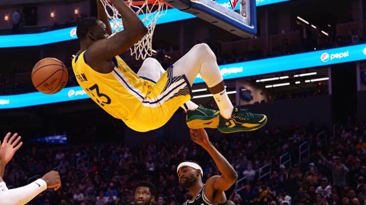 Dec 20, 2021; San Francisco, California, USA; Golden State Warriors forward Draymond Green (23) dunks the ball above Sacramento Kings forward-guard Maurice Harkless (8) during the fourth quarter at Chase Center. Mandatory Credit: Kelley L Cox-USA TODAY Sports