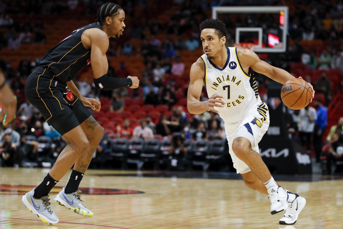 Dec 21, 2021; Miami, Florida, USA; Indiana Pacers guard Malcolm Brogdon (7) dribbles the basketball against Miami Heat forward KZ Okpala (11) during the first half at FTX Arena. Mandatory Credit: Sam Navarro-USA TODAY Sports