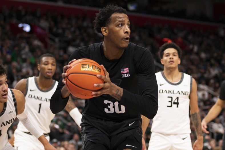 Dec 21, 2021; Detroit, Michigan, USA; Michigan State Spartans forward Marcus Bingham Jr. (30) gets control of the ball against the Oakland Golden Grizzlies during the second half at Little Caesars Arena. Mandatory Credit: Raj Mehta-USA TODAY Sports
