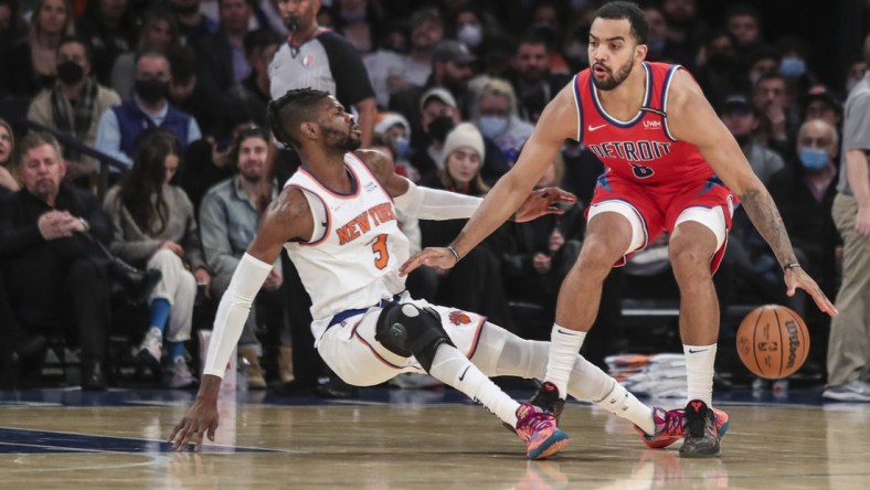 Dec 21, 2021; New York, New York, USA;  Detroit Pistons forward Trey Lyles (8) handles the ball as  New York Knicks center Nerlens Noel (3) falls to the floor in the third quarter at Madison Square Garden. Mandatory Credit: Wendell Cruz-USA TODAY Sports